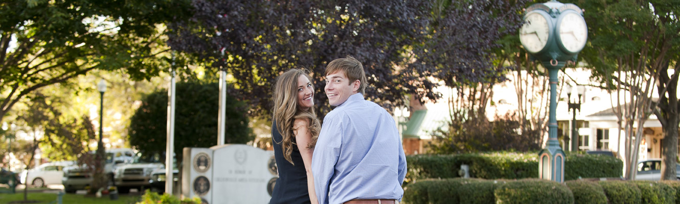 Young couple holding hands walking in the Collierville Square