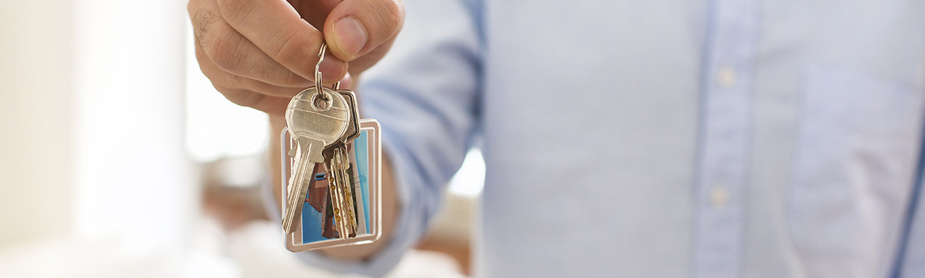 Close up of key holding house keys.
