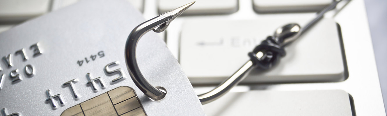 Card hooked with fishing line on keyboard.