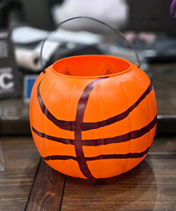 Pumpkin entry #9 - trick or treat orange pumpkin bucket painted with black stripes